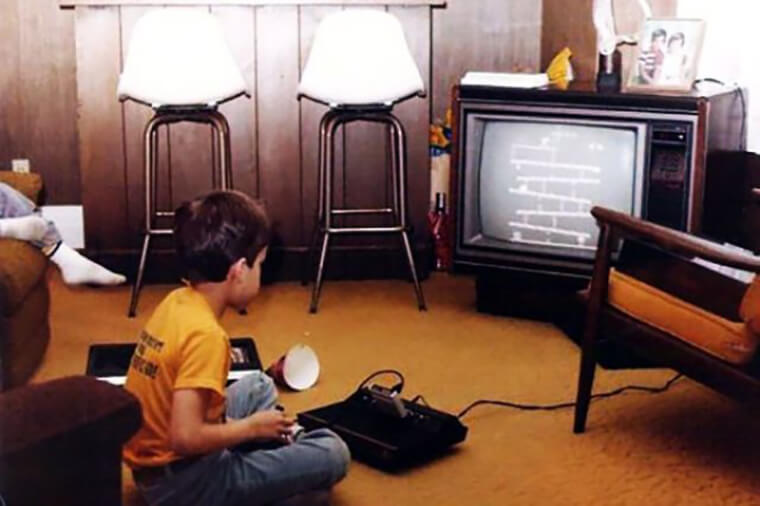 A Kid Playing Donkey Kong At Home
