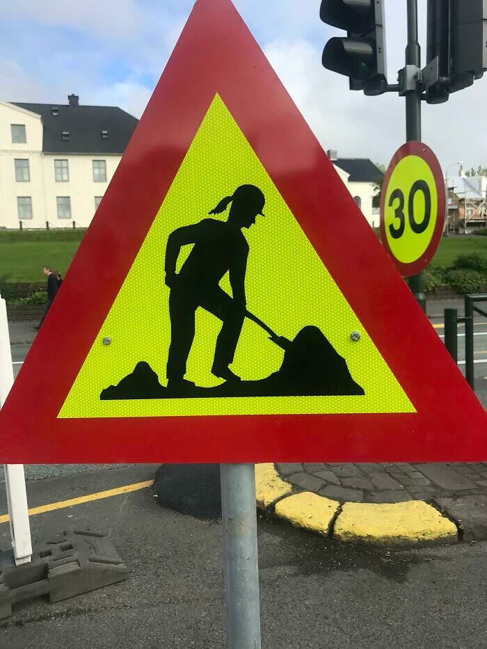 Iceland Features A Female Worker On Road Work Signs