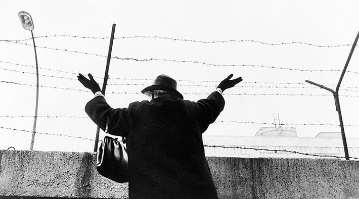 Woman in Berlin Wall's West Side Waits to See Her Family in East Berlin