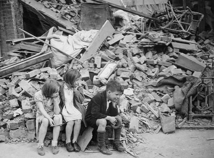 British Children Wait for Help Outside Their Bombed Home