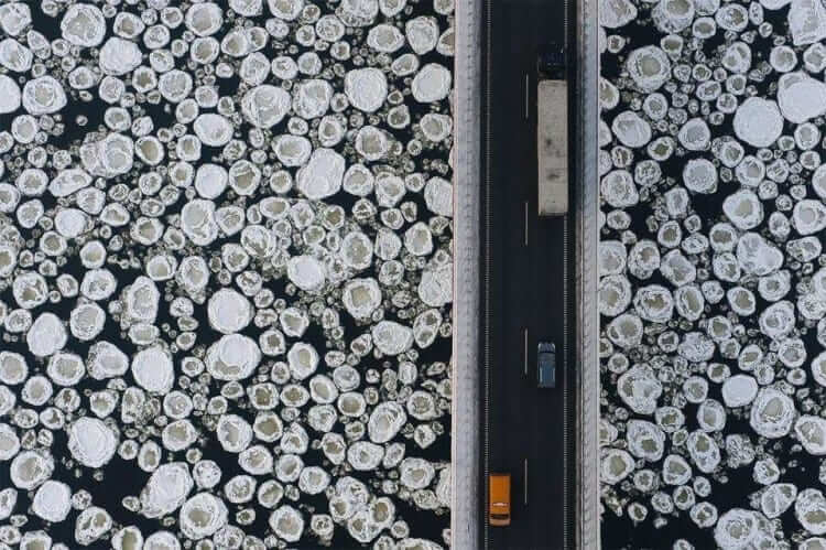 An Aerial View Of A Bridge Over A Frozen Lake