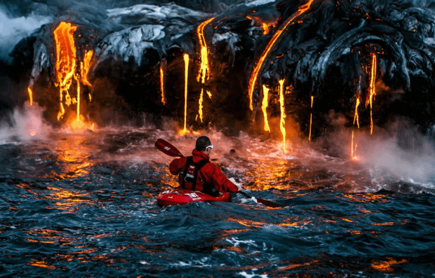 Someone Kayaking Up To Volcanic Lava