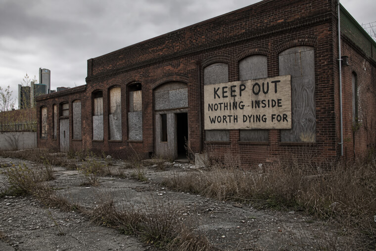 "Keep Out — Nothing Inside Worth Dying For" Warehouse Sign