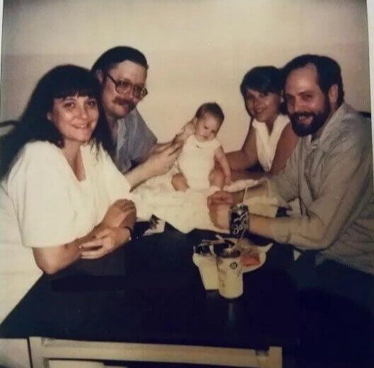 Ed Kemper Holding a Newborn Infant