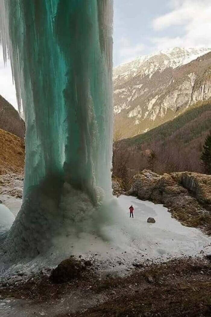 A Frozen Waterfall Towering in the Mountains
