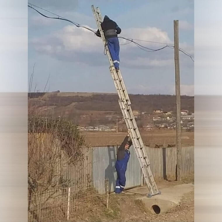 A Man Holding a Ladder Attached to a Ladder