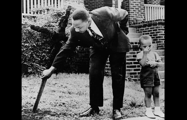 MLK Jr. Pulls A Burnt KKK Cross Out Of His Lawn