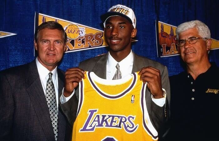 Kobe Bryant Holding Up His First NBA Jersey