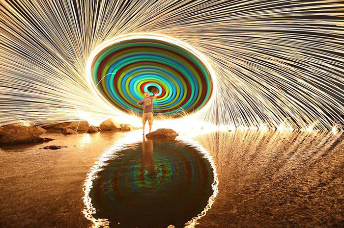 What It Looks Like To Swing A String Of Glow Sticks With Burning Steel Wool At The End