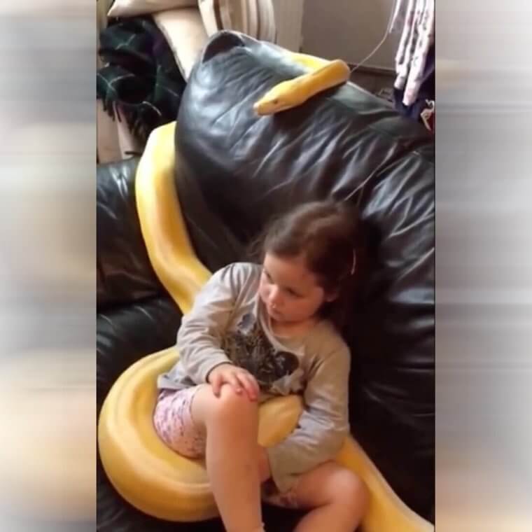 Just a Little Girl Watching TV With Her Snake