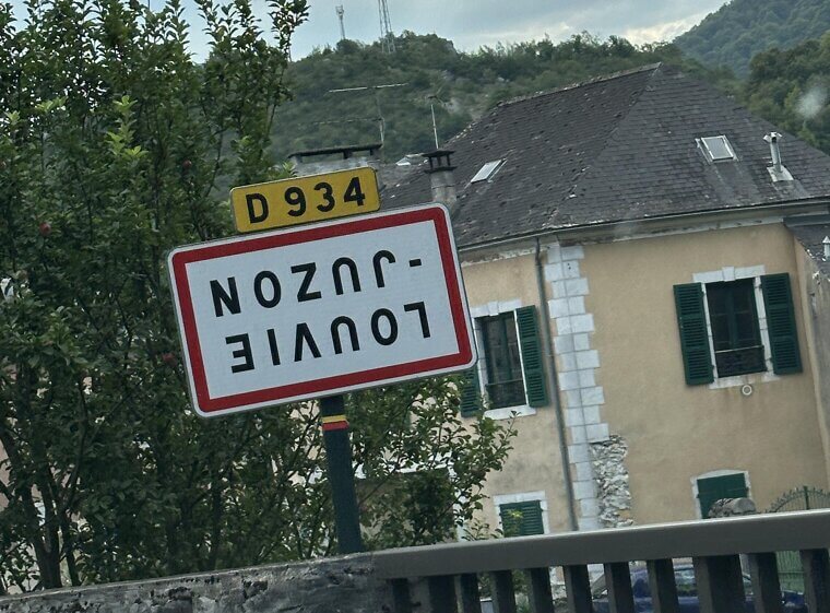 An Upside-Down French Town Sign