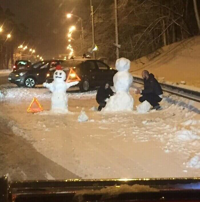 Russian Men Build Snowmen After Cars Crash