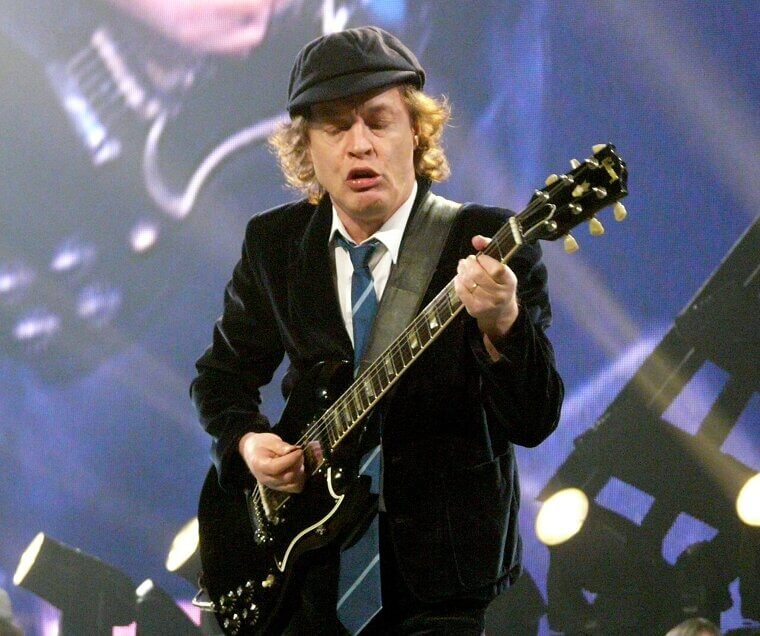 Angus Young Transforms Into His Alter Ego by Donning a Classic Schoolboy Uniform