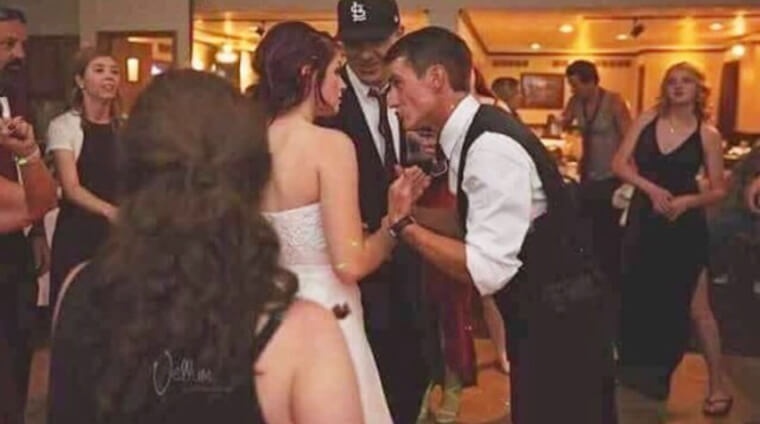 Either This Bride Has Her Backside Out or This Wedding Guest Has Perfect Timing