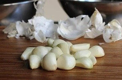 Press Down on Garlic With the Flat Side of a Knife - It'll Make Peeling a Breeze