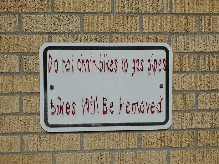 A Sun-Worn Sign That Looks Like It Belongs In A Horror Film