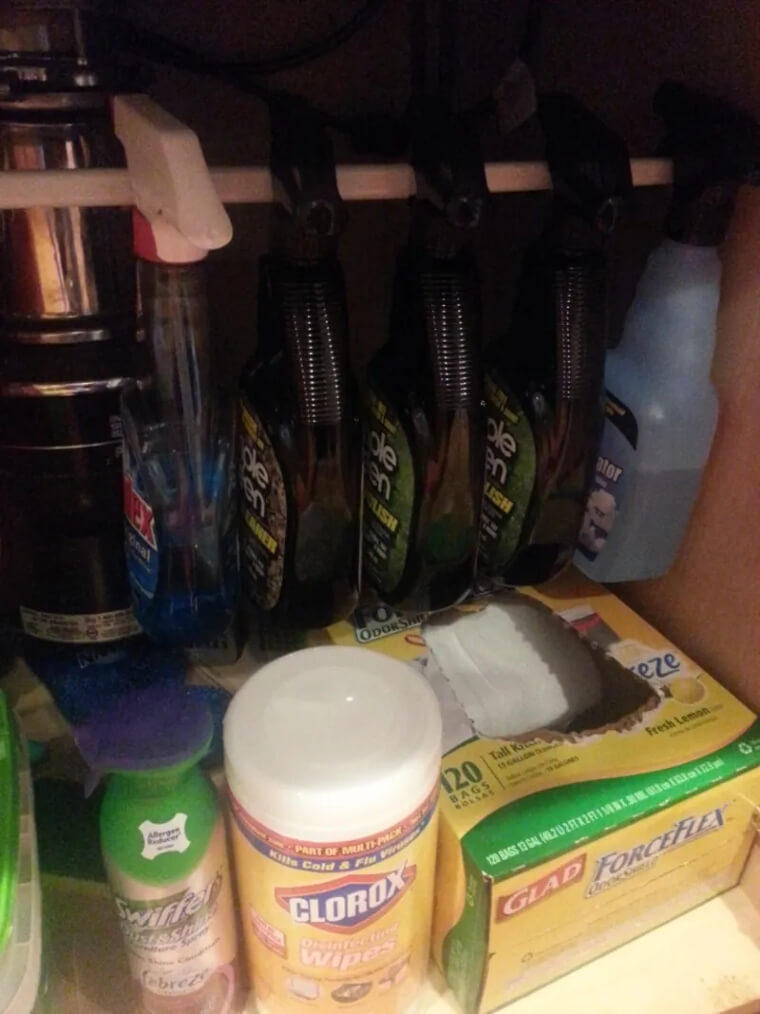 Organize Cleaning Product Cabinets With a Tension Rod