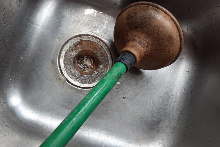 Plunging a Drain Cleaner-Filled Sink