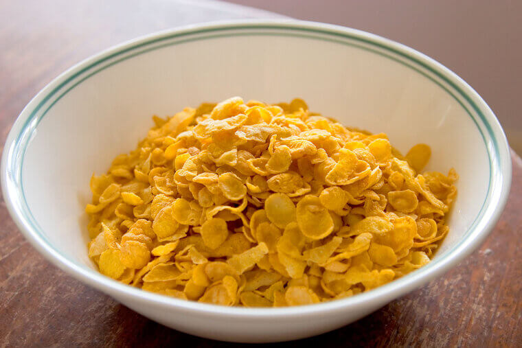 The Kellogg brothers salvaged a stale batch of boiled wheat dough by rolling it out, miraculously creating the first crunchy Corn Flakes