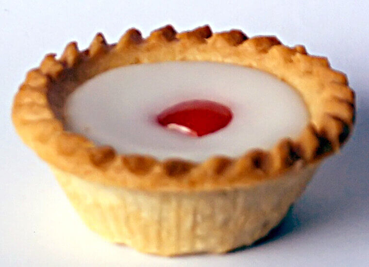 A busy kitchen maid ignored instructions and spread fruit jam directly under a sponge topping, creating the beautifully layered traditional Bakewell Pudding