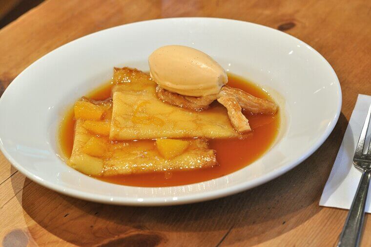 A panicking young waiter accidentally set a pan of crepes on fire in front of future royalty, luckily creating the elegant Crepes Suzette