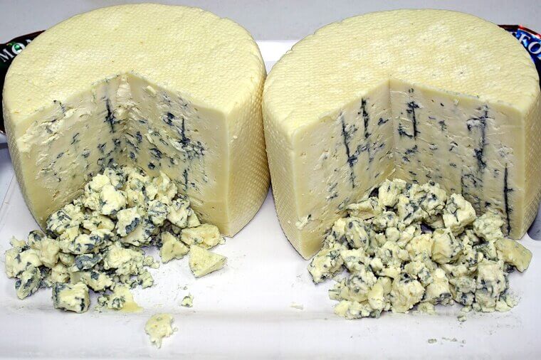 A distracted cheesemaker abandoned his lunch in a damp cave to chase a beautiful woman, accidentally cultivating the sharp and pungent blue cheese