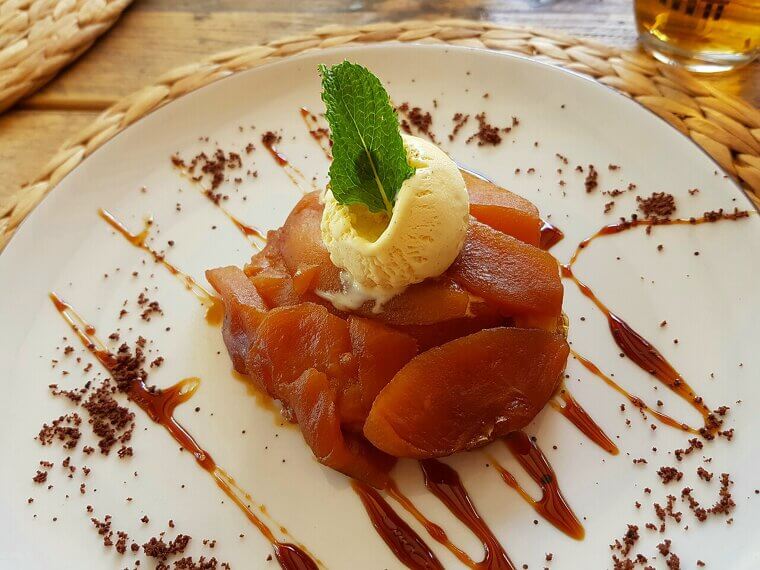 A distracted hotel manager tried to save her overcooked apples with a hasty pastry cover, inadvertently baking the famous Tarte Tatin