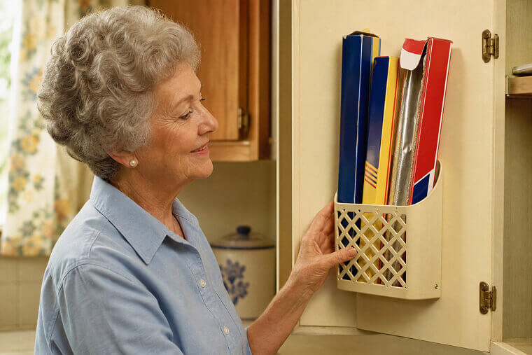 Attach Magazine Holders to Cabinet Doors for Foil Rolls