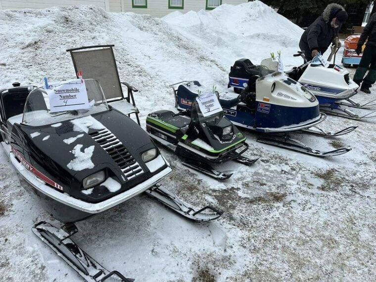 Vintage Snowmobiles Parked in Back