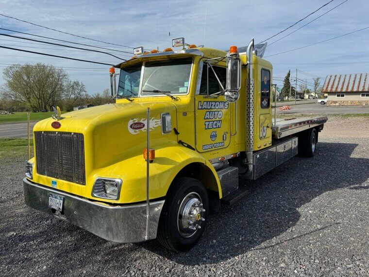 ​2003 Peterbilt 330 Rollback Tow Truck: $32,000