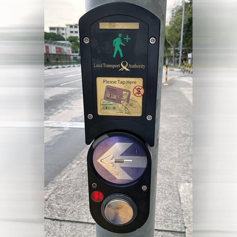 Tapping a Senior Citizens Card That Allows for More Time Crossing the Street