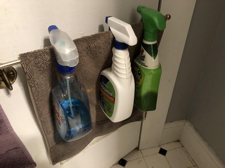 Use A Towel Bar To Hold Cleaning Spray Bottles