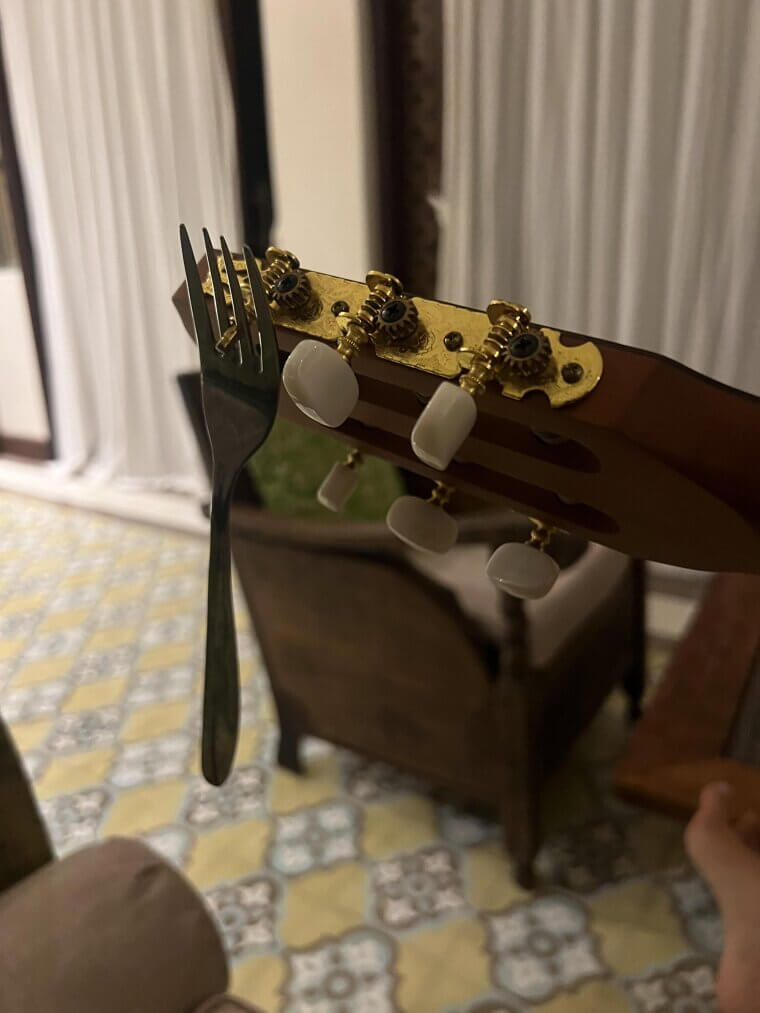 Use A Fork To Hold Guitar Strings In Place