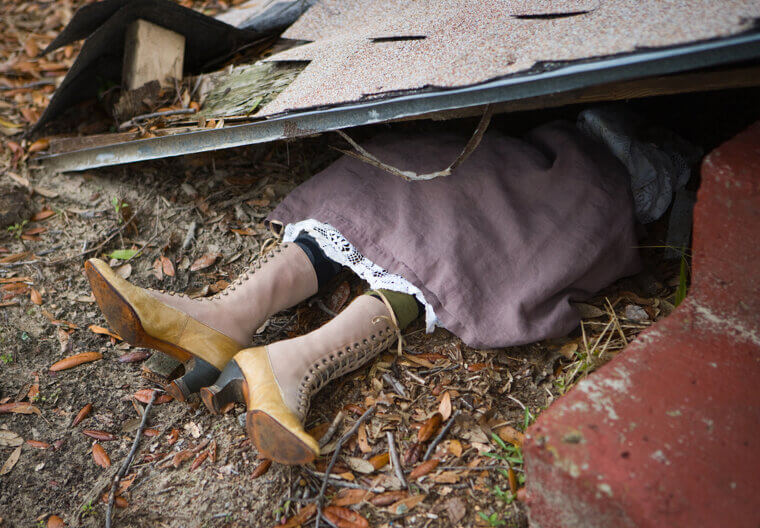 The Wizard Throws a Wooden House in the Air During "A Sentimental Man" - A Reference to Dorothy's Flying House