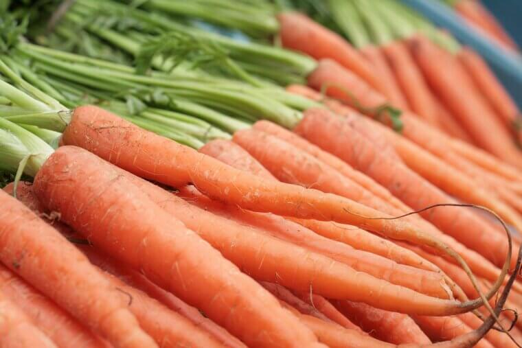 Dropping a Whole Carrot Into Simmering Tomato Sauce to Naturally Absorb Excess Tart Acidity