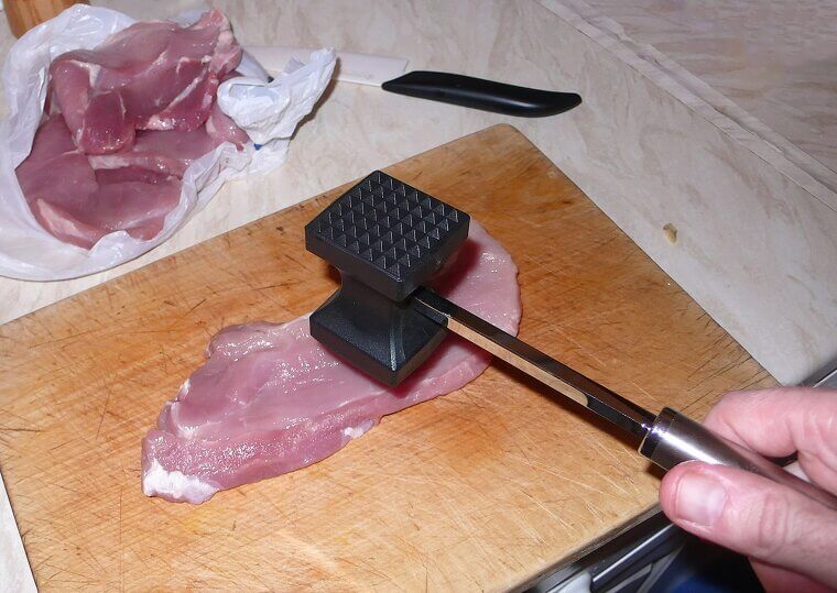 Pounding Raw Protein With a Heavy Metal Mallet to Break Down Dense Tissues for Easy Chewing