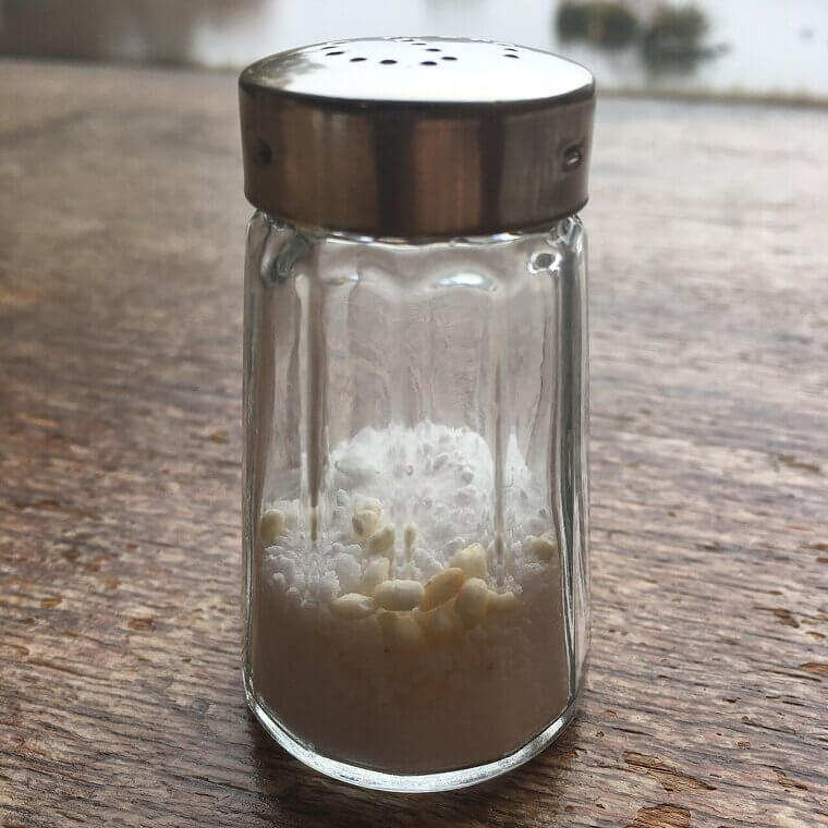 Adding Uncooked Rice to Salt Shakers to Absorb Moisture and Prevent Condiments from Clumping