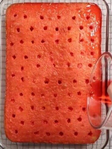 Poking Holes in a Sponge Cake To Pour In Jell-O and Create a Visually Beautiful Cake