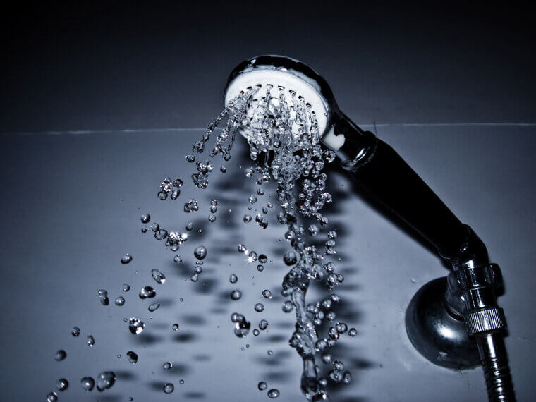 Washing your face with very hot water in the shower