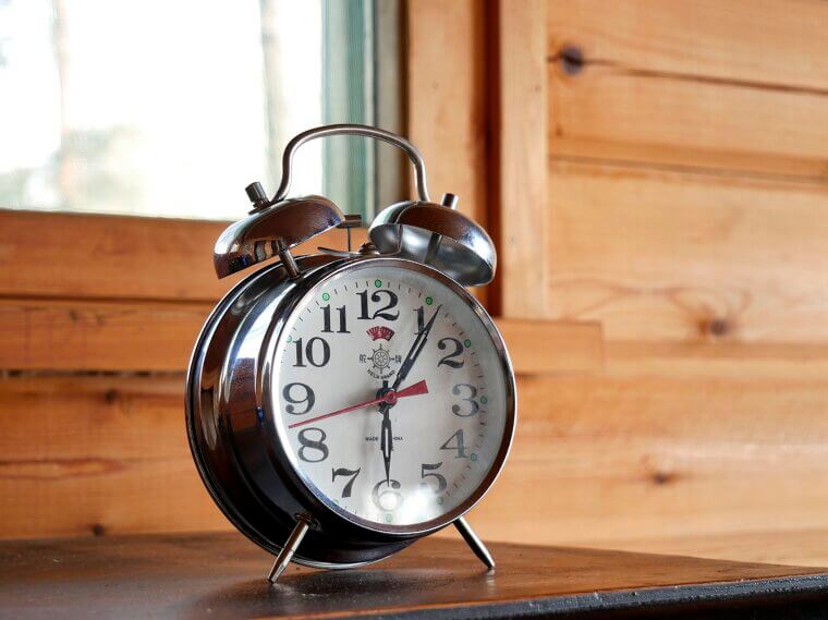 Using a loud, jarring alarm clock to wake up