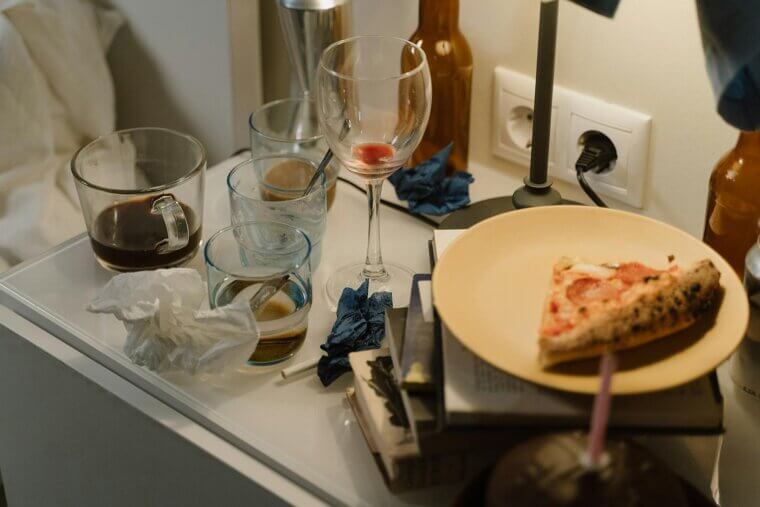 Neglecting to clear your nightstand of clutter and dishes