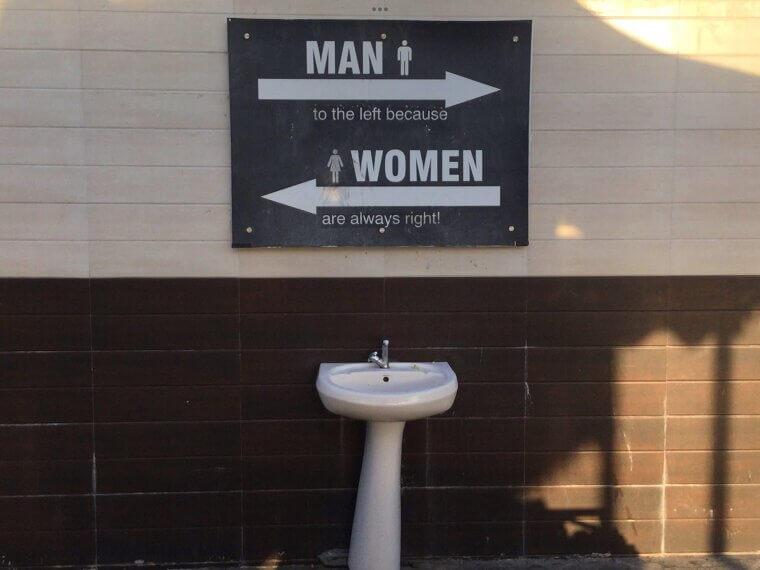 A Bathroom Sign With Its Own Logic
