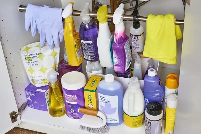 Use a Tension Rod to Store Spray Bottles