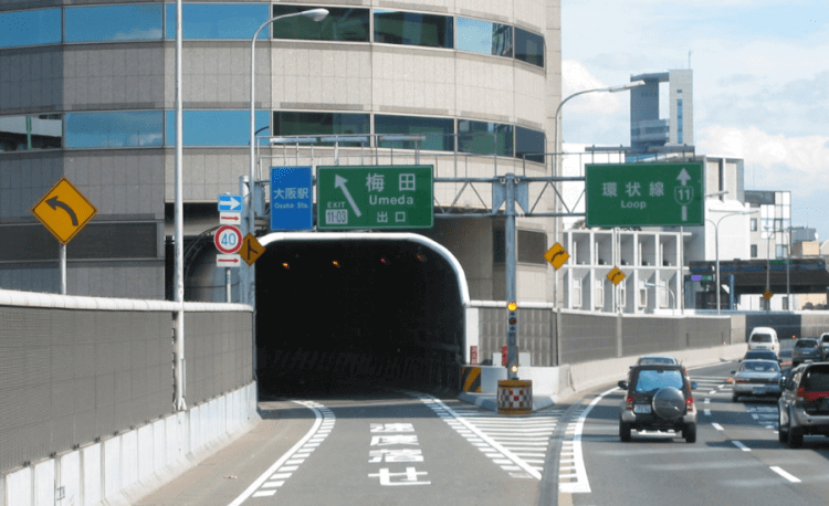 There Is A Building With A Highway Passing Through It