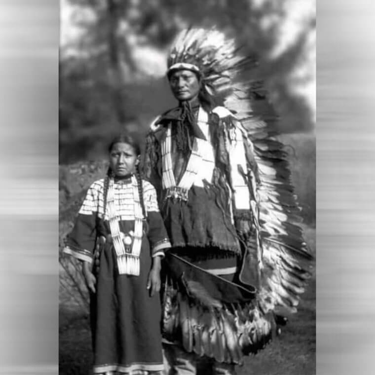 A Native American Man and His Daughter in Traditonal Dress